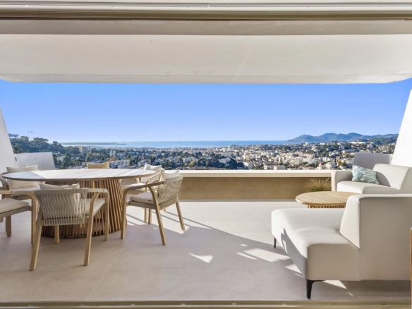 Panoramic view from a renovated apartment in Le Cannet, with modern furniture and sea view.