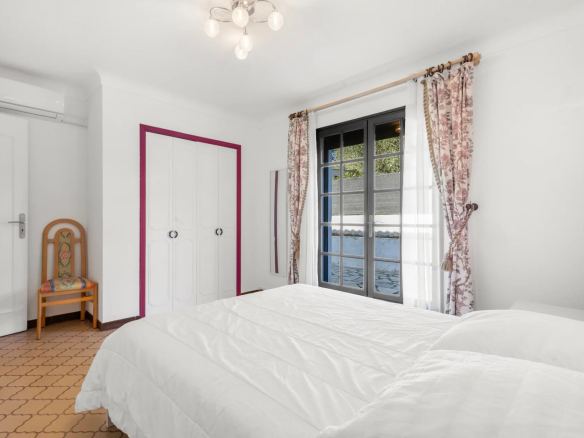 Room in a villa in Mougins with two single beds and windows overlooking the outside.
