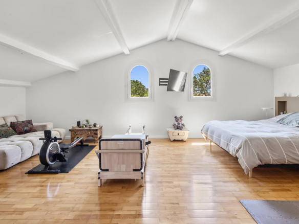 Interior of a renovated villa with a large living space and arched windows.