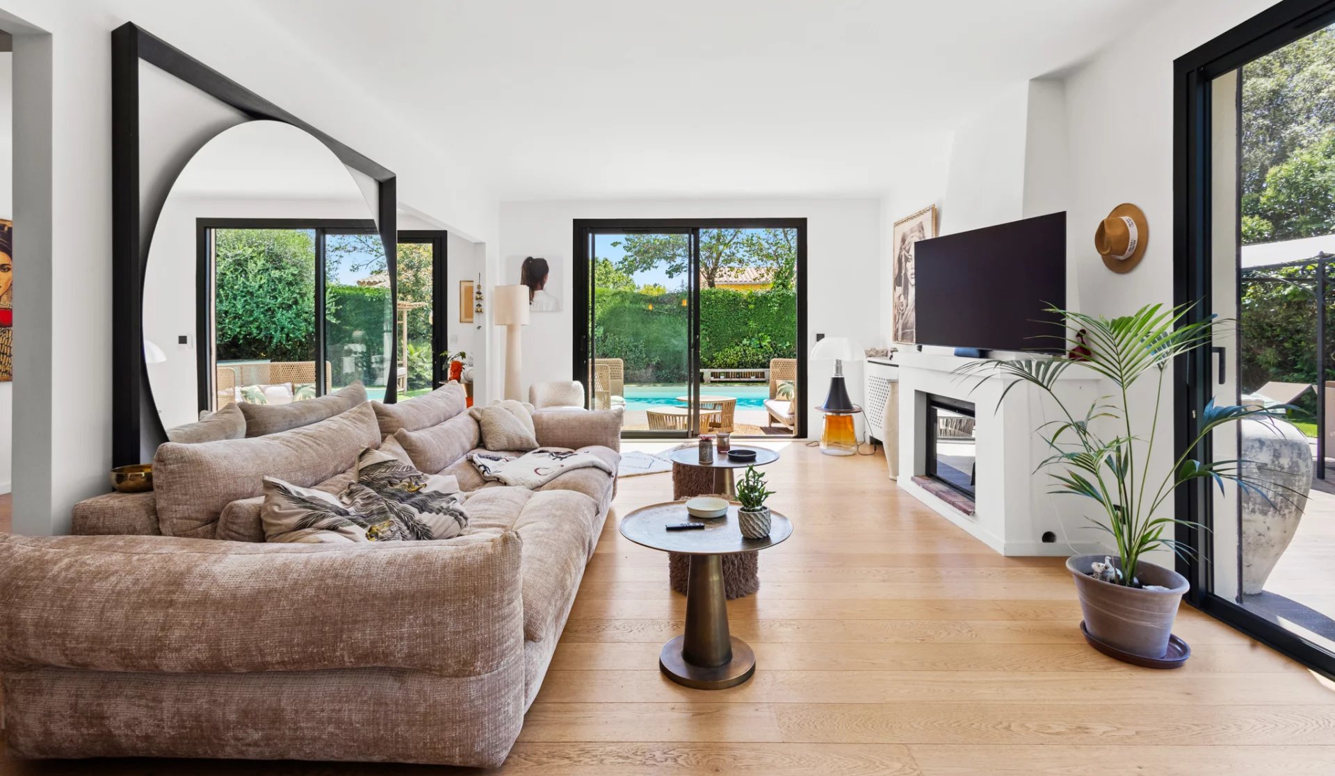 Living room of a renovated villa in Mougins Interior of a renovated villa with a bright and modern living room, overlooking the outdoor pool.
