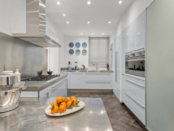 Modern and bright kitchen with stainless steel appliances and a steel worktop, Le Cannet.