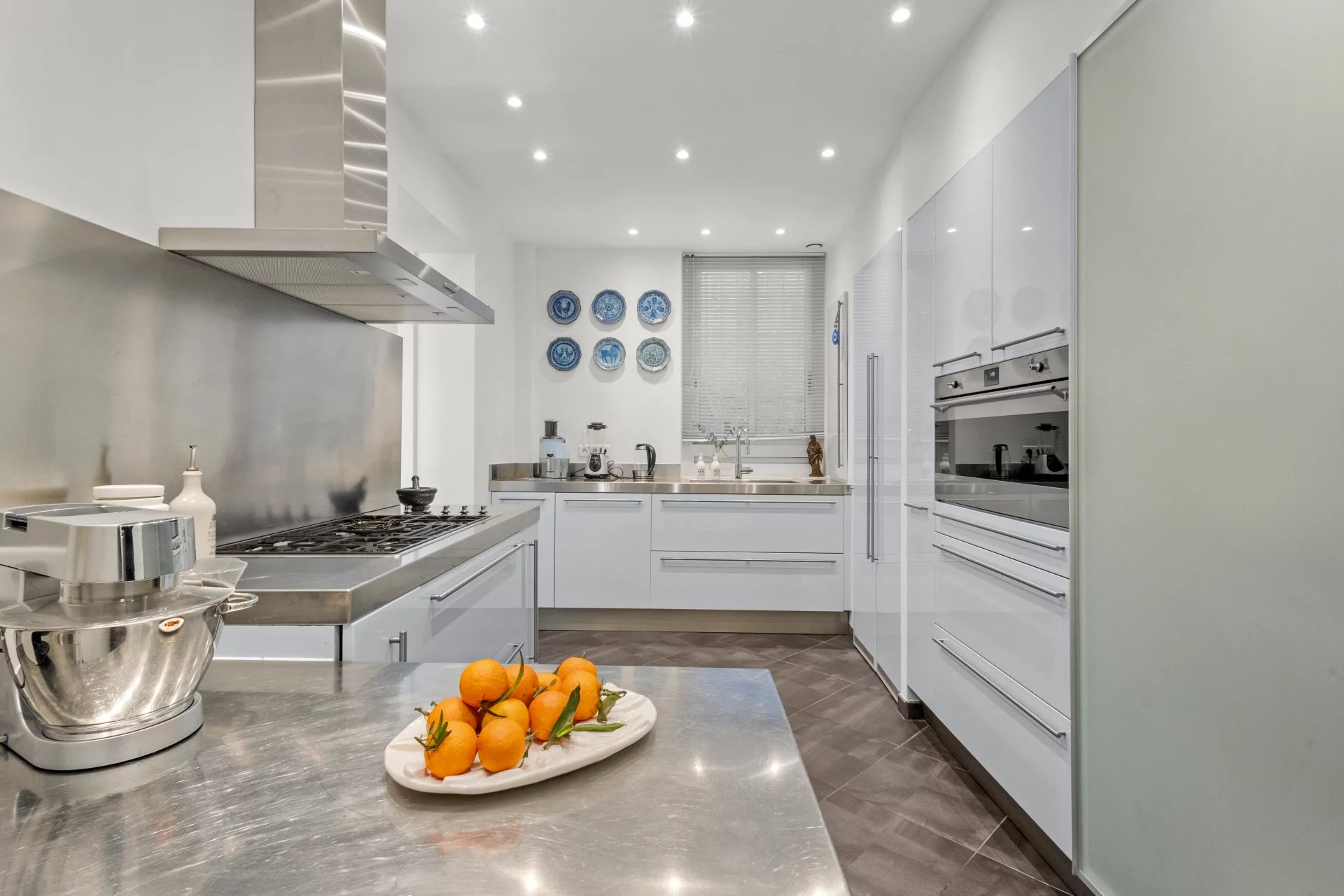 Modern and bright kitchen with stainless steel appliances and a steel worktop, Le Cannet.