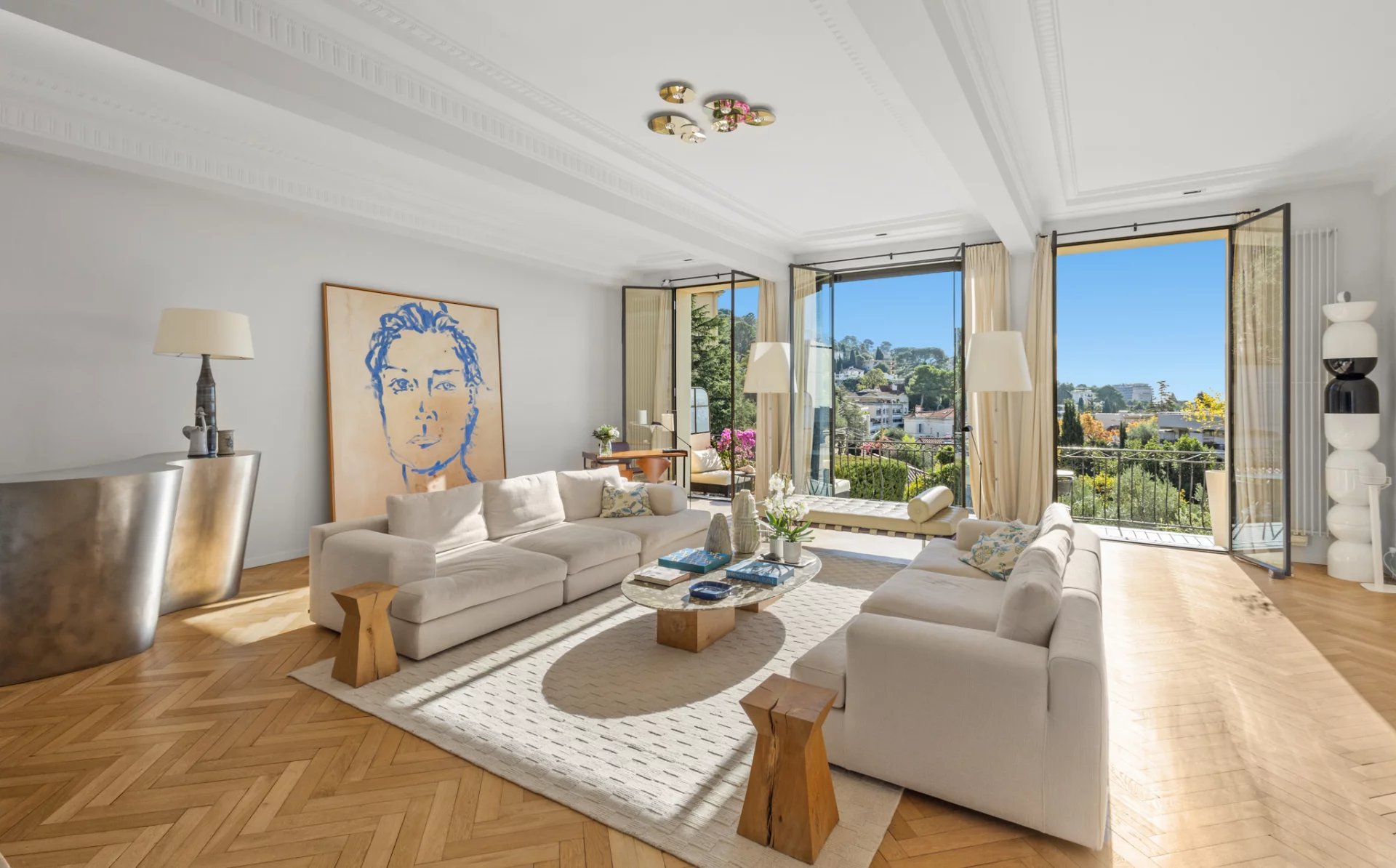 Interior of a renovated private mansion with a bright living room and sea view.