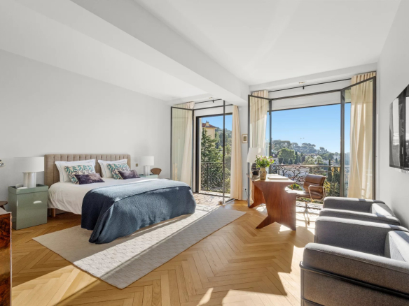 Spacious room with sea view, open windows, modern and bright furniture.