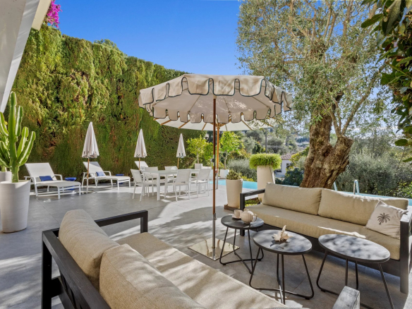 Terrace of a private mansion with sea view, garden furniture and swimming pool.