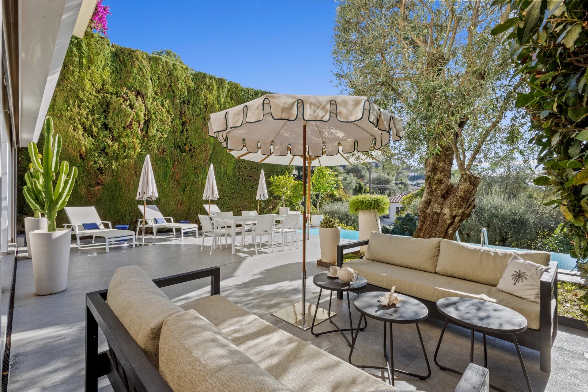 Terrace of a private mansion with sea view, garden furniture and swimming pool.