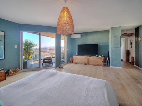 Interior of a top-floor apartment with sea views, modern and bright decor.