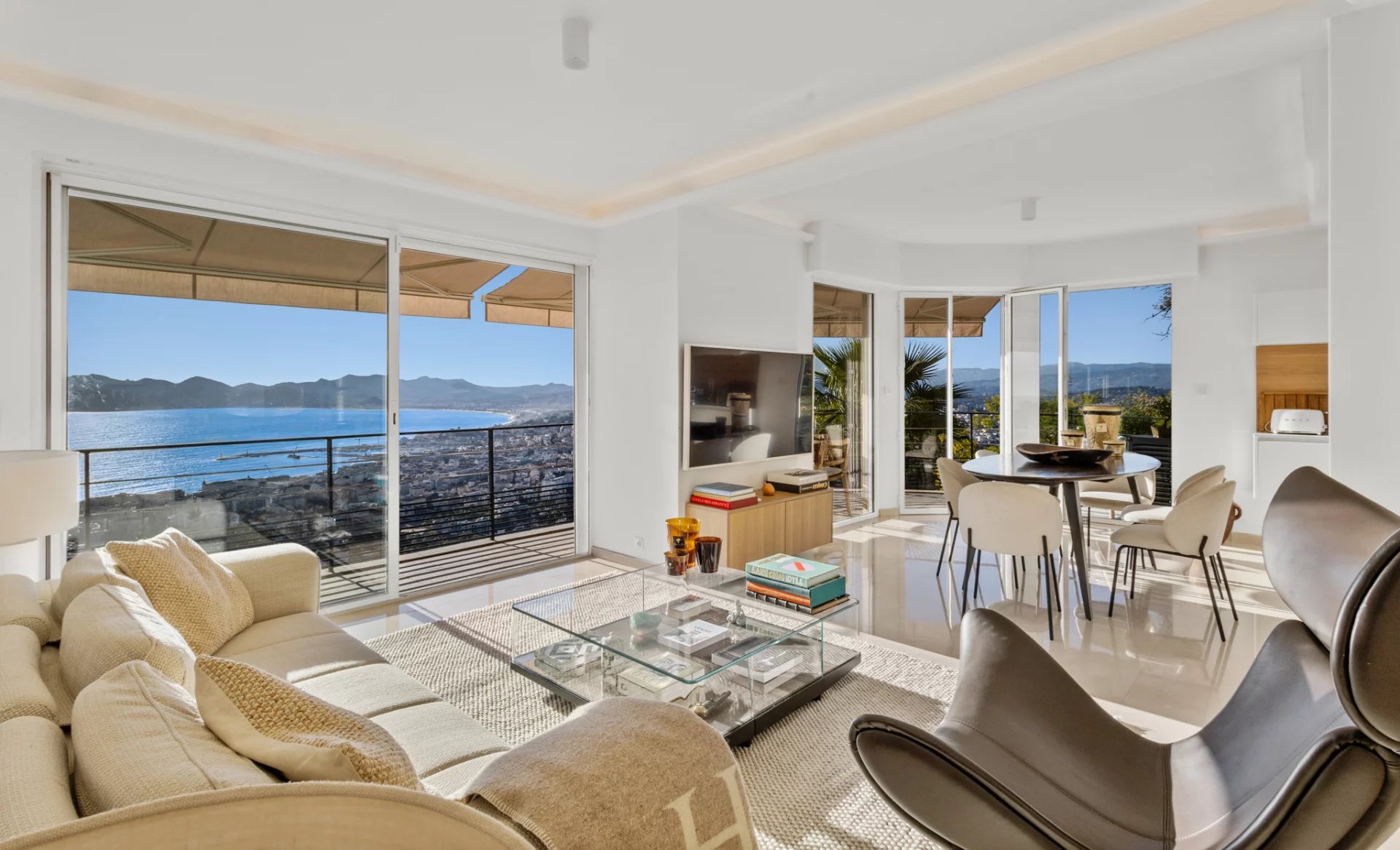 Appartement avec vue mer à Cannes Intérieur d'un appartement moderne avec vue sur la mer, salon lumineux et mobilier contemporain.