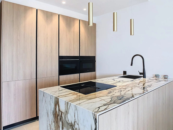 Modern kitchen with marble island in an elegant apartment in Cannes.