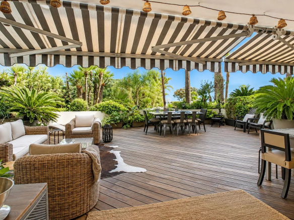 Spacious terrace with garden furniture and sea view in Cannes Palm Beach.