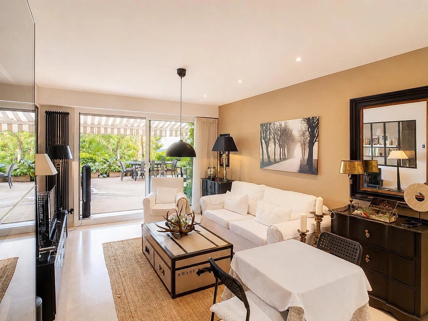 Interior of an elegant apartment with a bright living room, tasteful decor and access to a terrace.