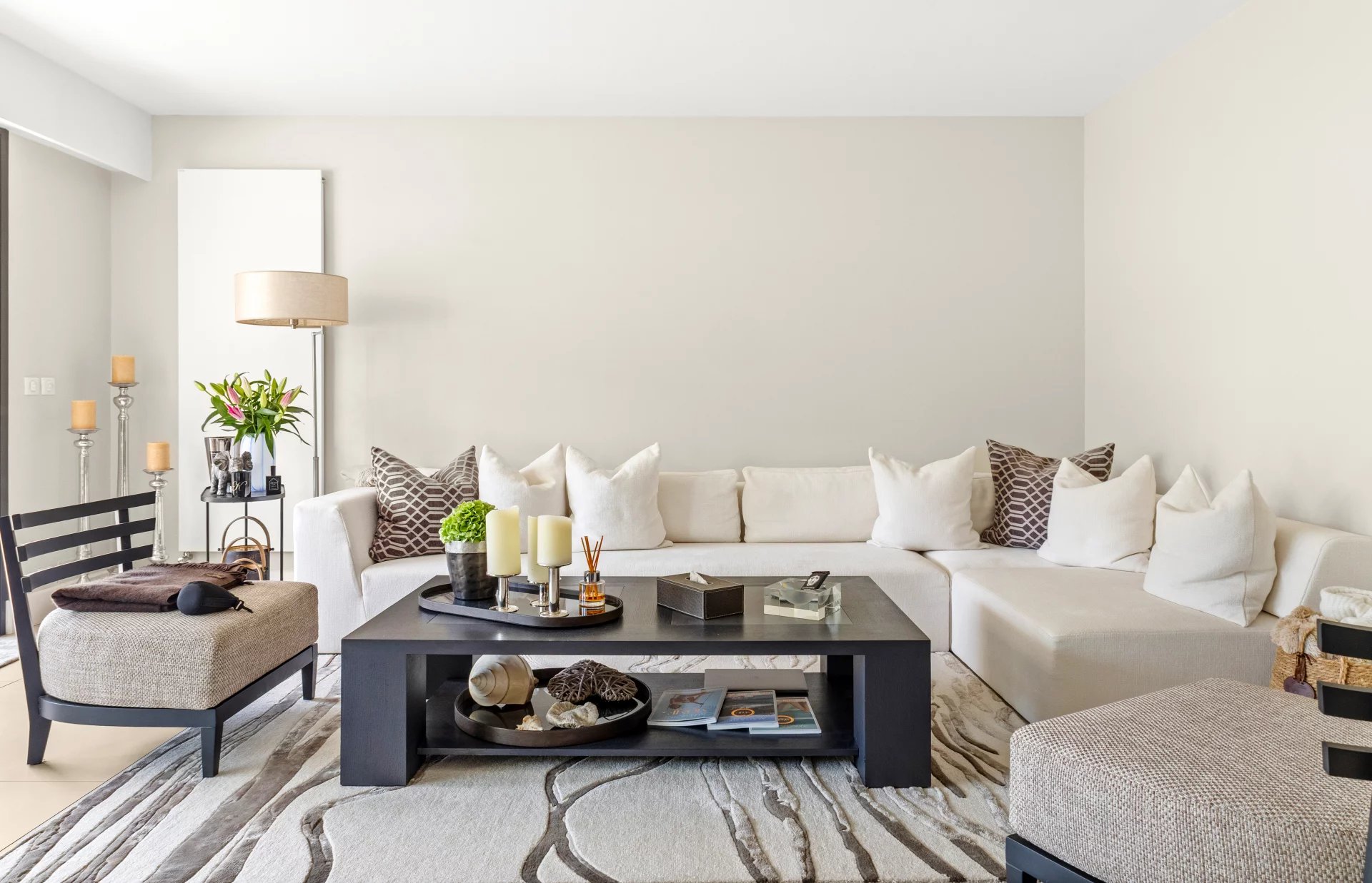 Elegant living room of a renovated apartment Living room of a renovated apartment, with white sofa, coffee table and modern decor.