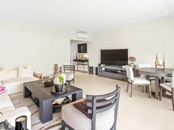 Interior of a renovated apartment with living room, dining room and access to a terrace.