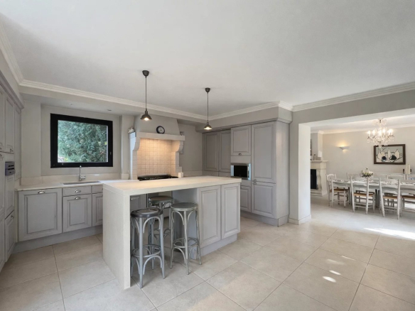 Modern kitchen with central island and garden view, in a villa in Opio.