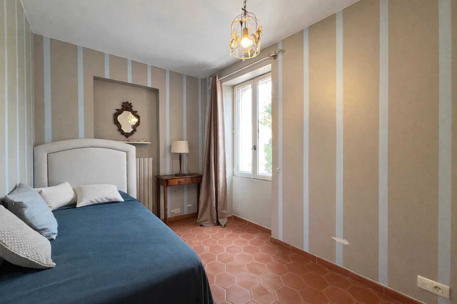 Villa room in Opio Bedroom in a villa with bed, mirror and window overlooking the outside.