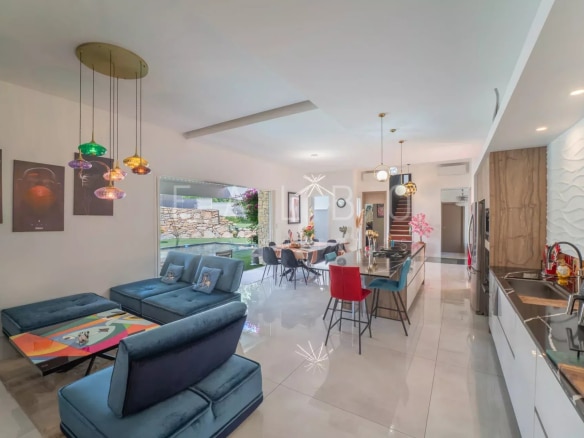 Modern interior of an architect-designed villa with living room and open kitchen in La Ciotat.