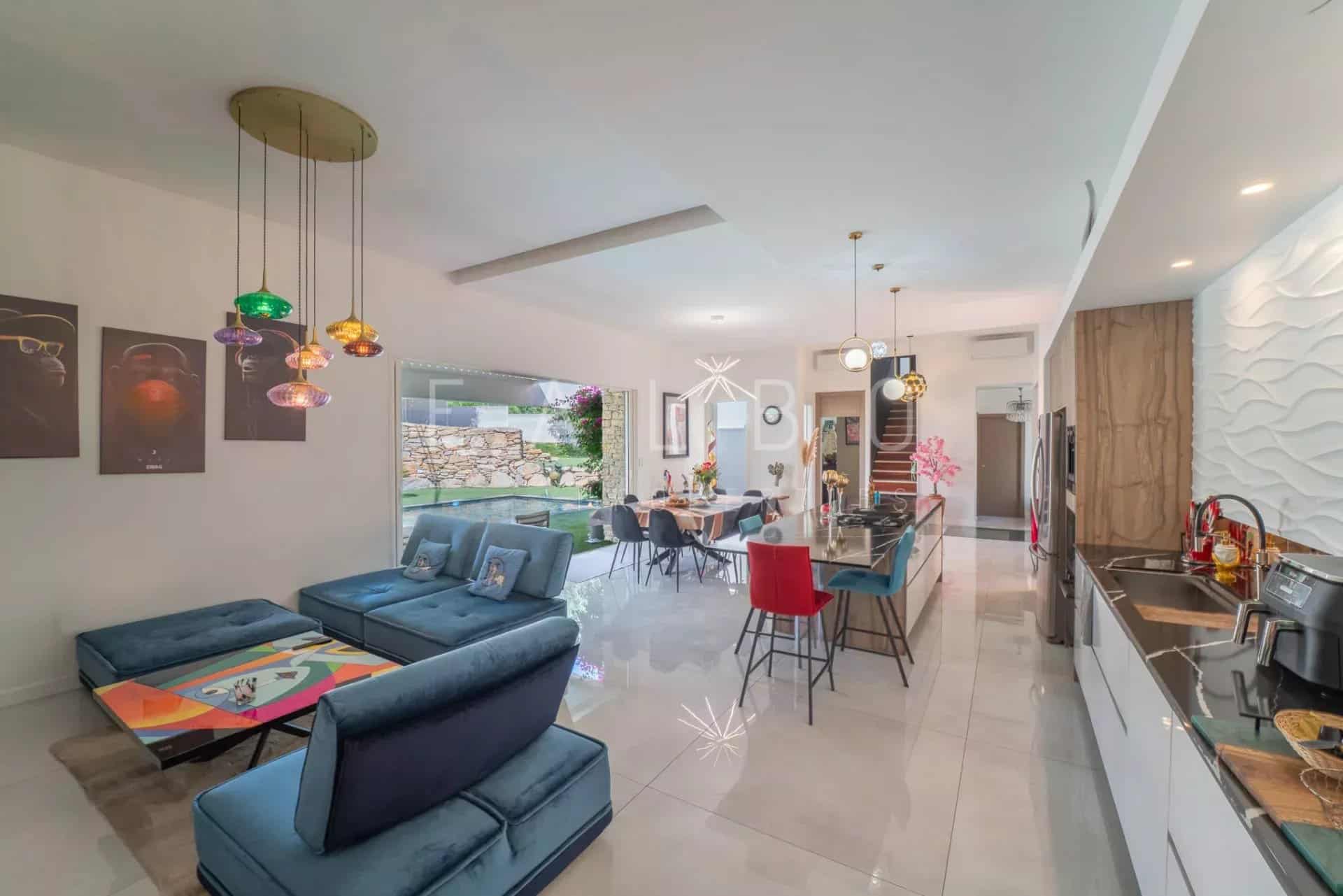 Modern interior of an architect-designed villa with living room and open kitchen in La Ciotat.