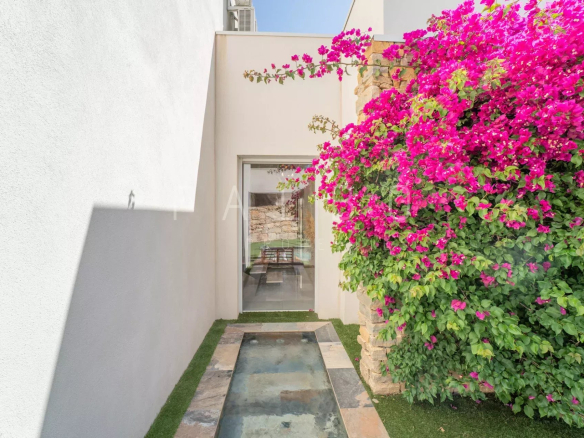 Entrance to a contemporary villa with a water feature and flowering bougainvillea in La Ciotat.