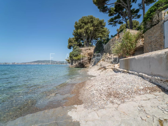 Pebble beach in La Ciotat, seaside with trees in the background.