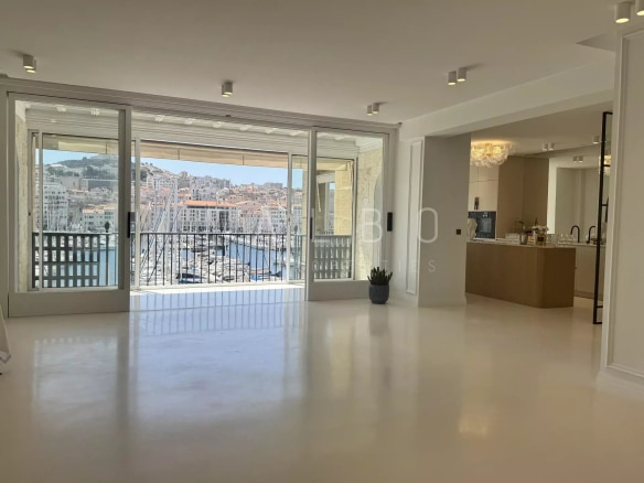 Interior of a renovated apartment with a view of the Old Port of Marseille.