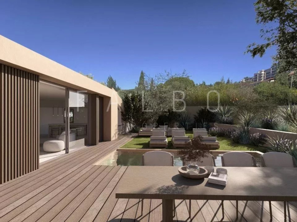 Terrace of a modern villa with outdoor furniture and garden in Cassis.