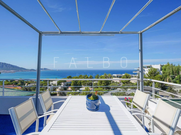 Terrace of a contemporary villa with sea view in Marseille, white outdoor furniture.