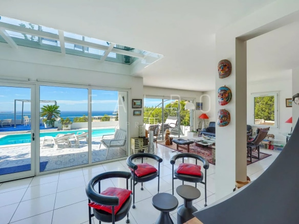 Interior of a contemporary villa with sea views, bright living room and outdoor pool.