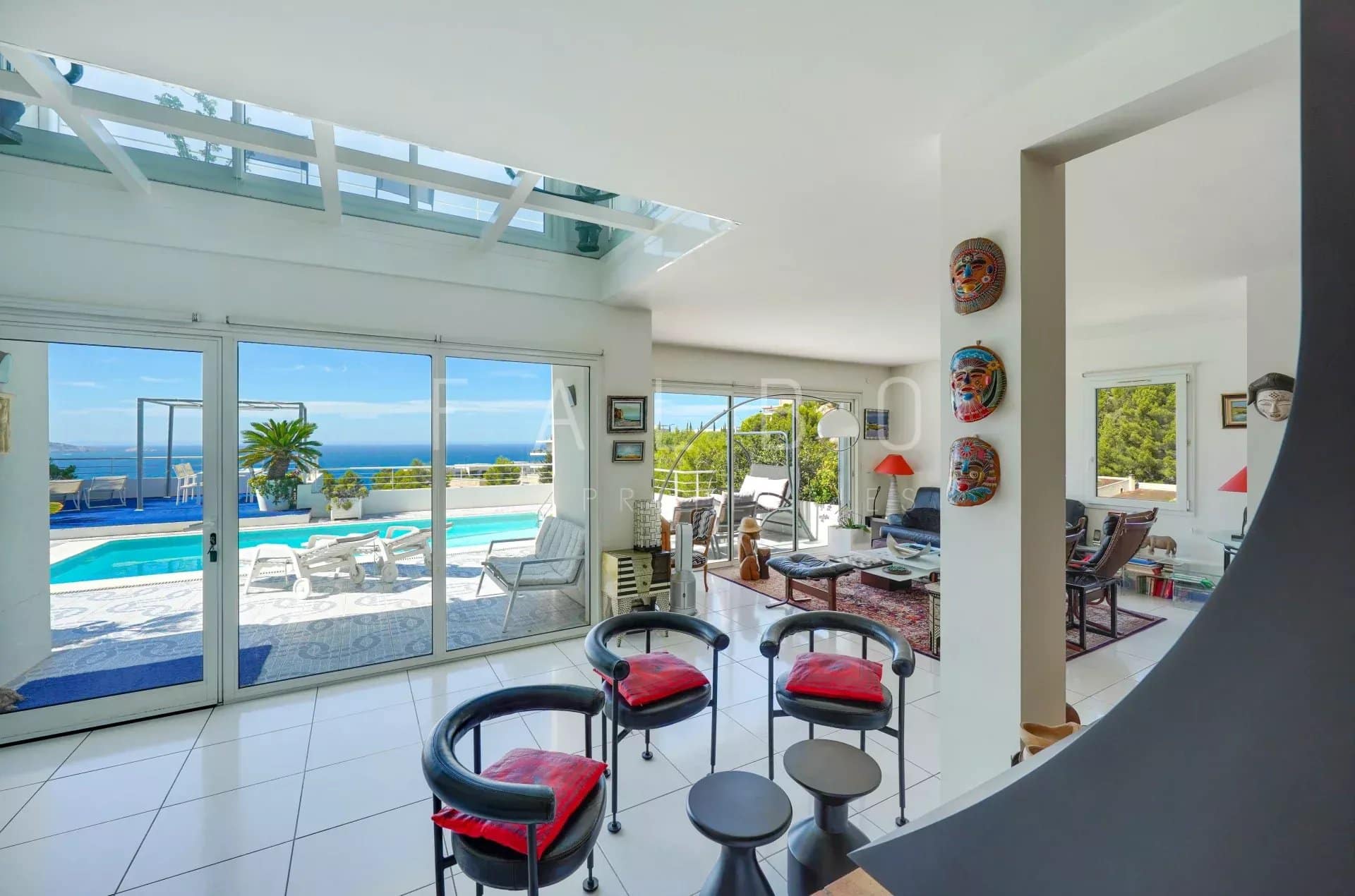 Interior of a contemporary villa with sea views, bright living room and outdoor pool.