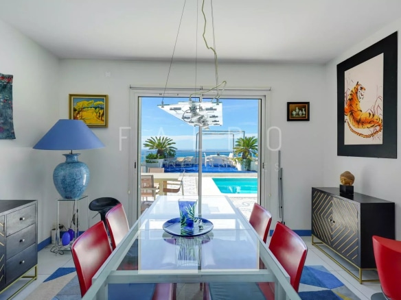 Interior of a contemporary villa with sea view, dining room and access to the swimming pool.