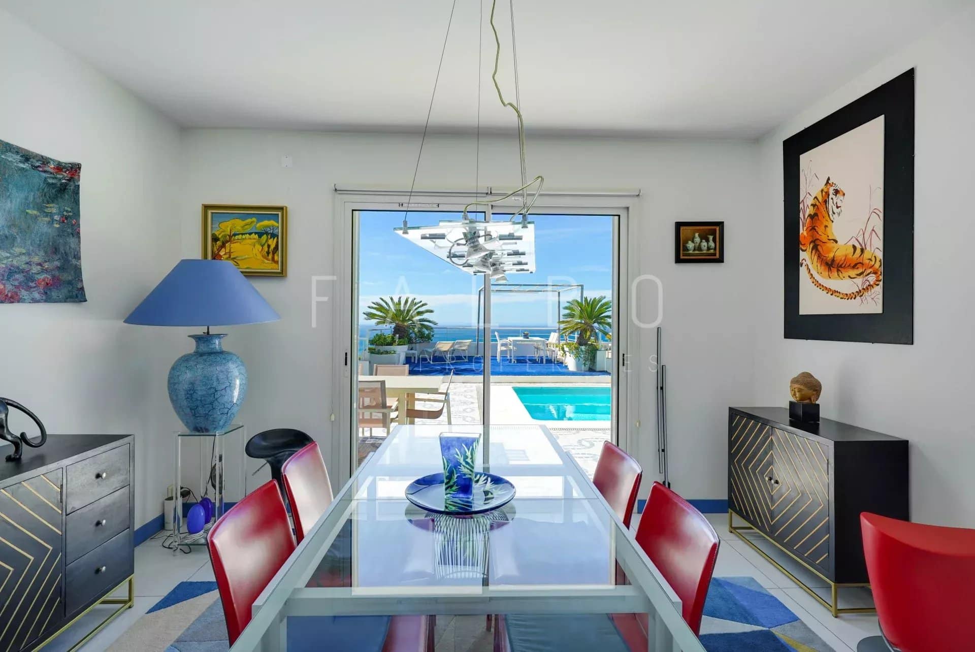 Interior of a contemporary villa with sea view, dining room and access to the swimming pool.