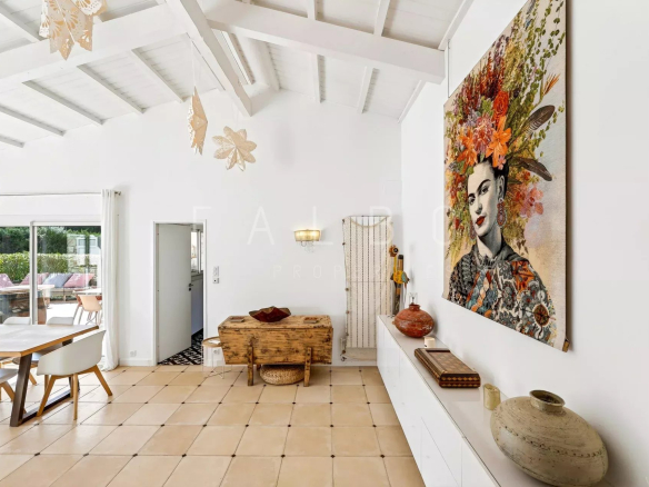 Interior of a villa with artistic decoration, bright living room and dining area.