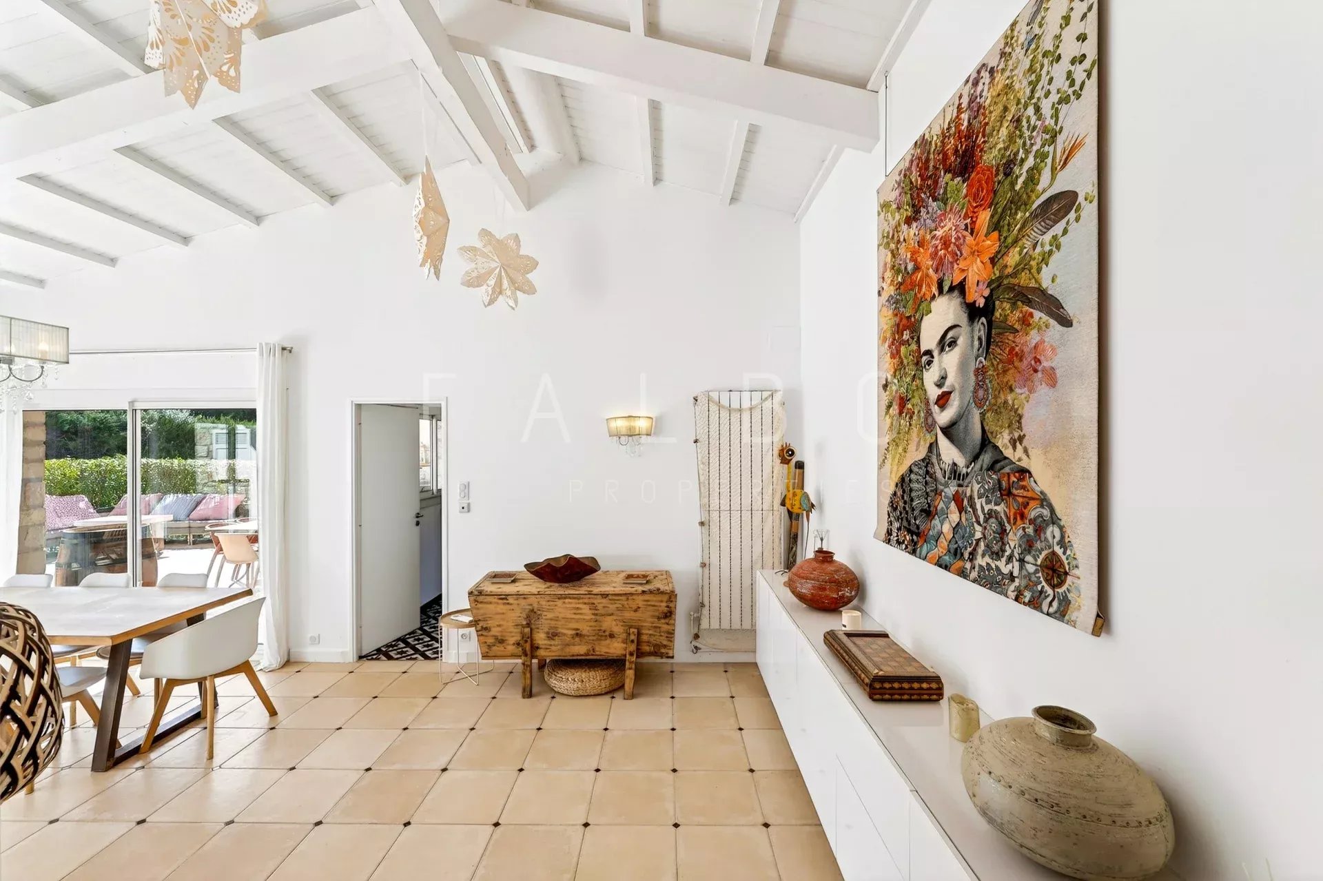 Interior of a villa with artistic decoration, bright living room and dining area.