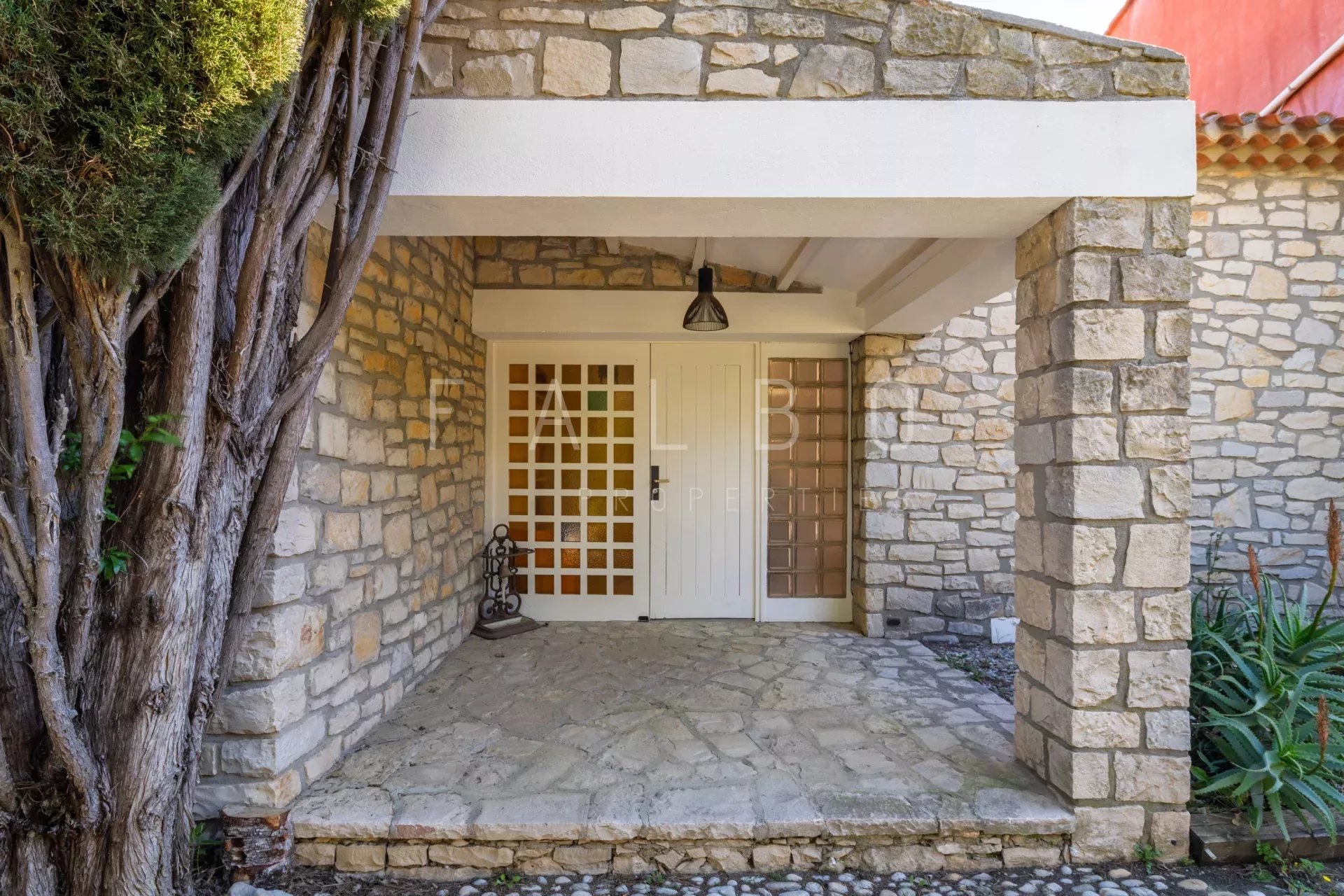 Entrance to a stone villa with a porch and stone floor, La Ciotat.