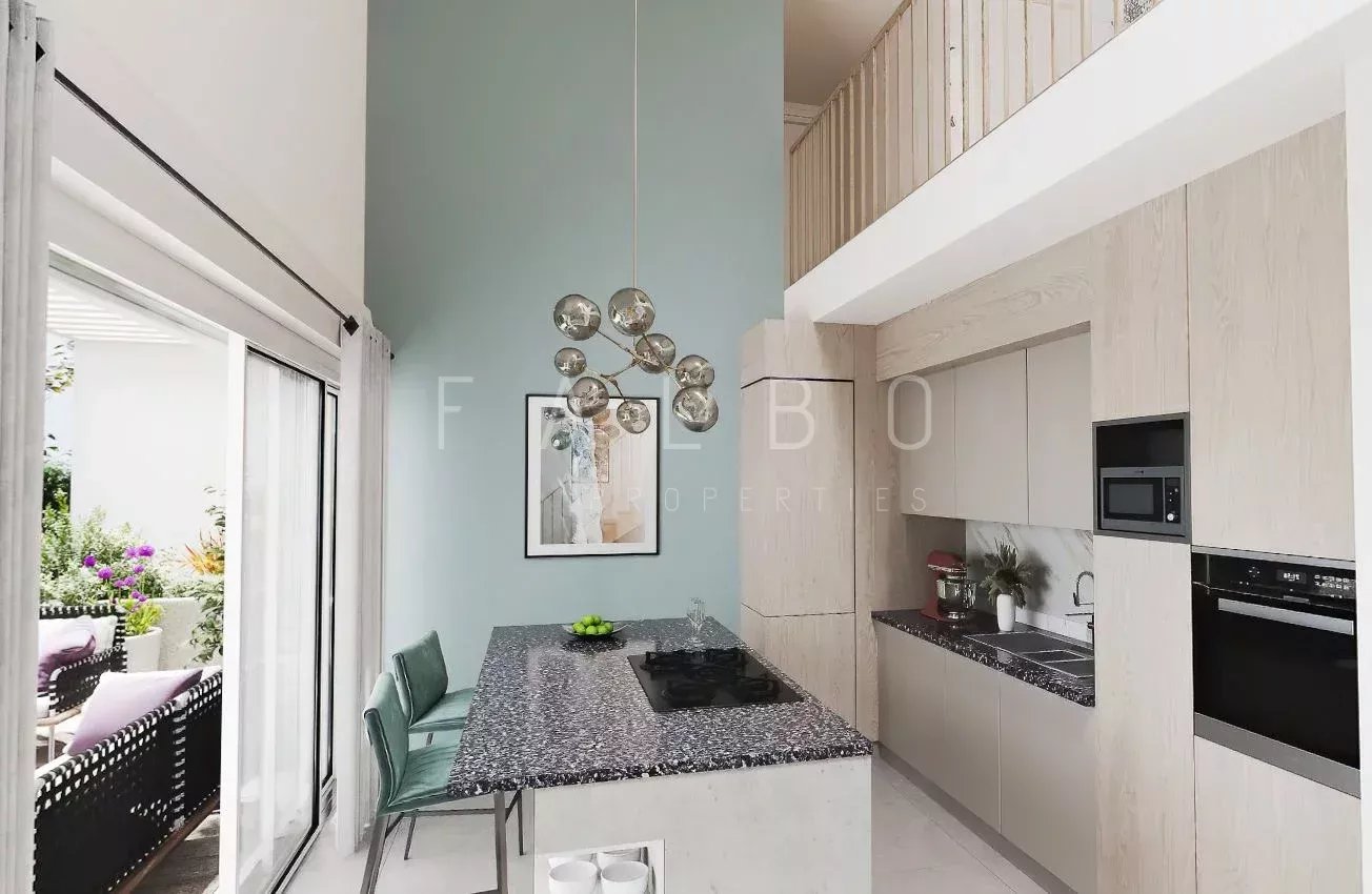 Modern and bright kitchen in a 6-room apartment in Marseille 6th district with central island and access to a terrace.
