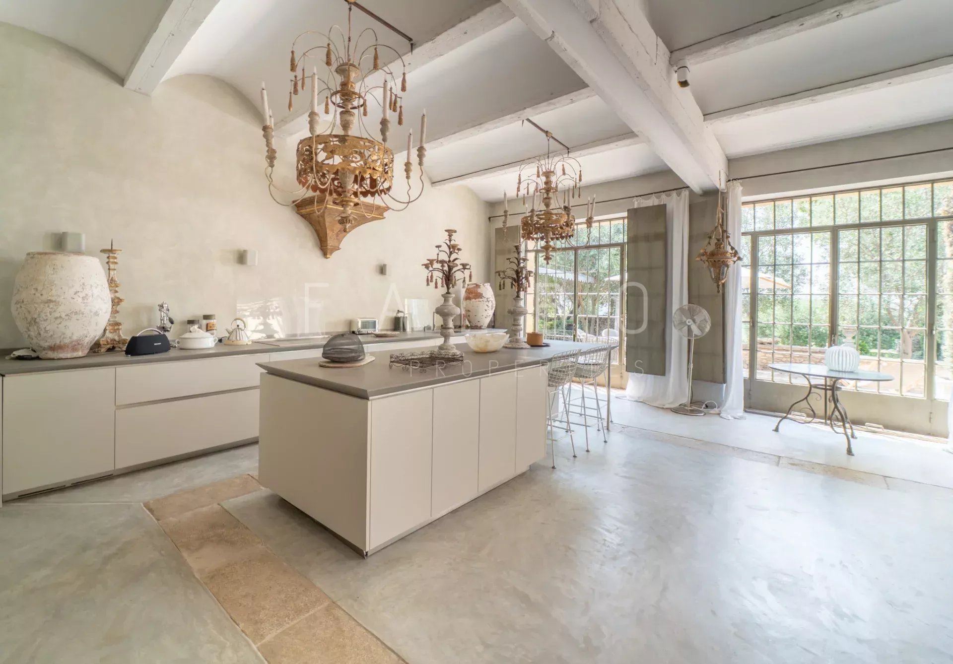Modern kitchen in a stone farmhouse Interior of a modern kitchen in a stone farmhouse, with a large worktop and decorative elements.