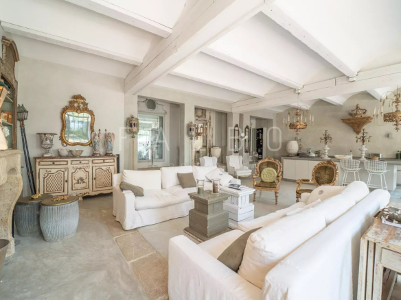 Interior of a renovated Provençal farmhouse with a large living room and elegant furniture.