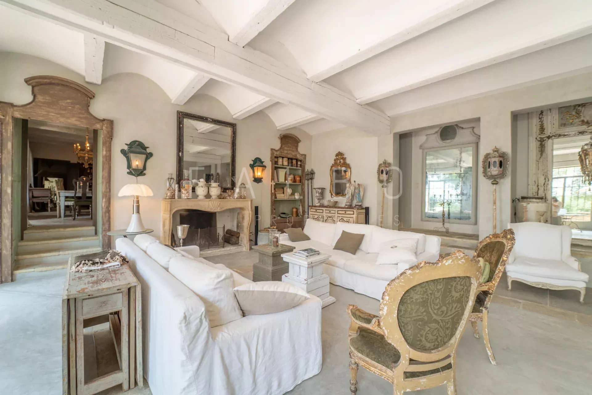 Interior of a Provençal farmhouse Interior of a stone farmhouse with a spacious living room, elegant furniture and a fireplace.
