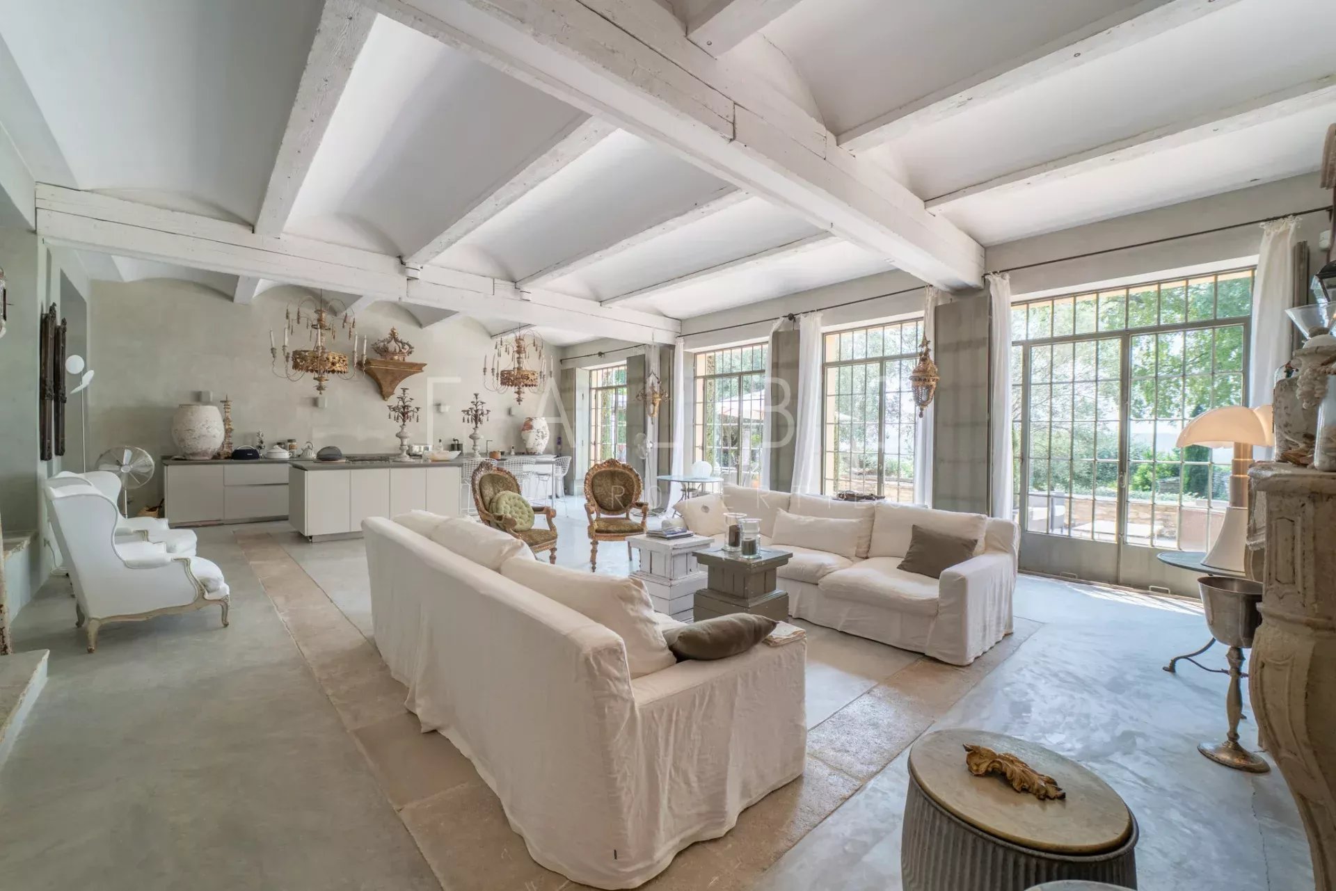Interior of a Provençal farmhouse Interior of a stone farmhouse with a large, bright living room and elegant furniture.