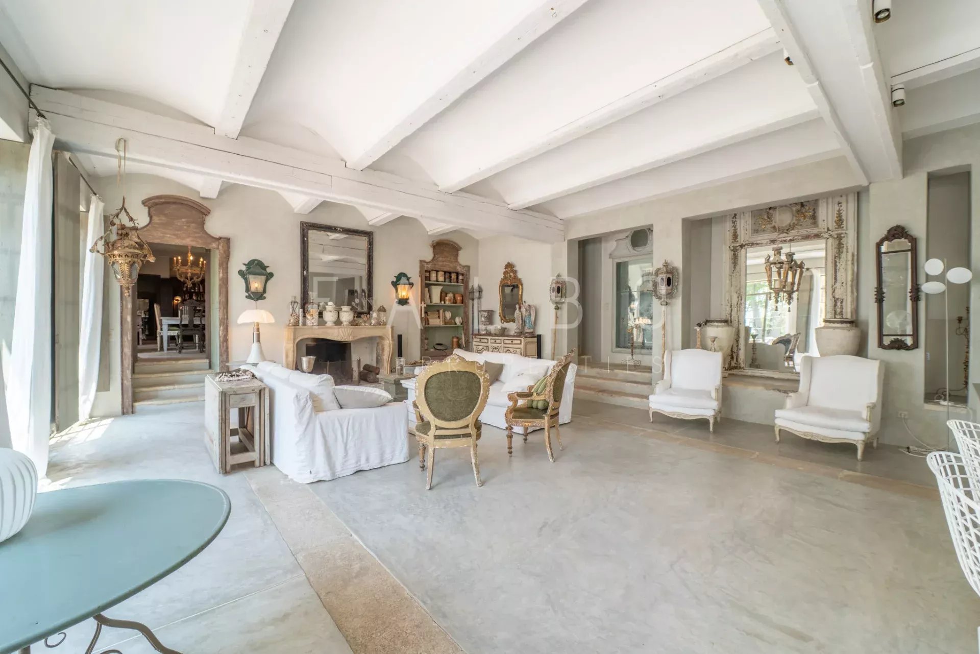 Interior of a Provençal farmhouse Interior of a renovated Provençal farmhouse with a large, bright living room and elegant decorative elements.