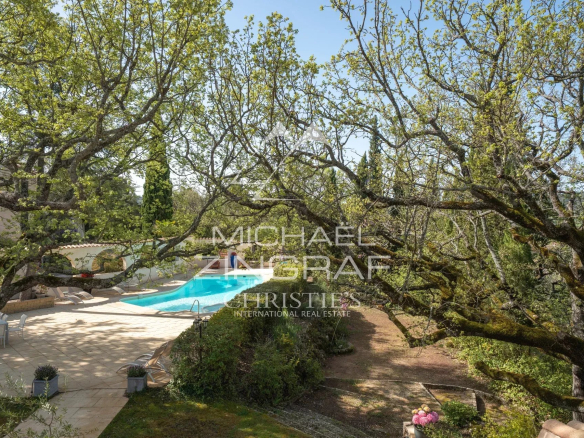 View of the estate with swimming pool surrounded by trees in Rians, Provence.