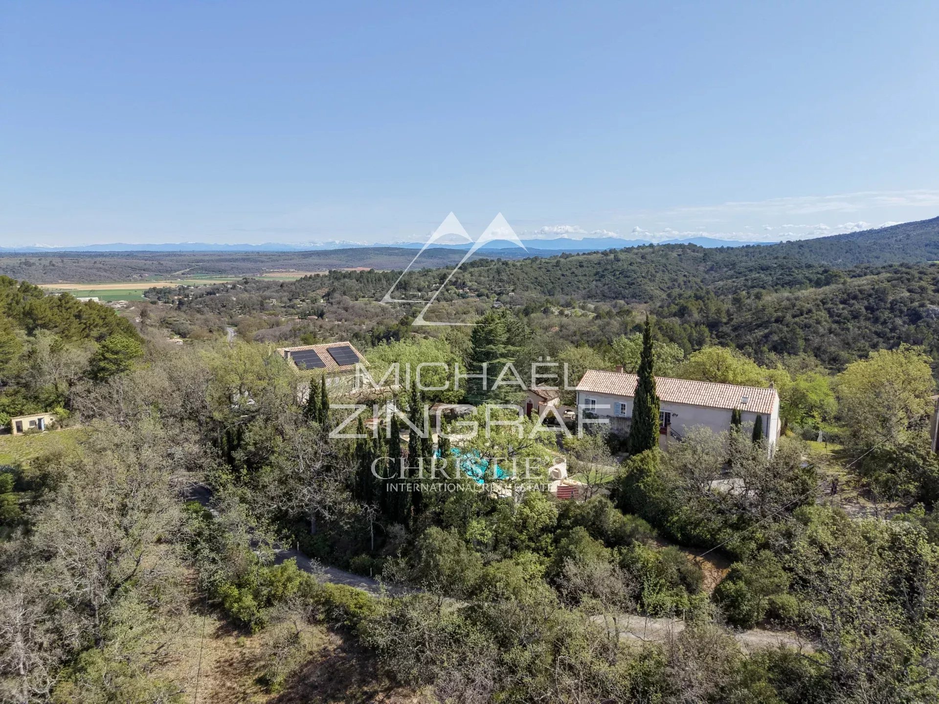 Aerial view of a Provençal estate with swimming pool and wooded park in Rians, near Aix-en-Provence.