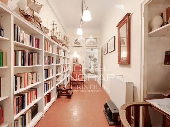 Interior of a library with shelves filled with books and decorative items.