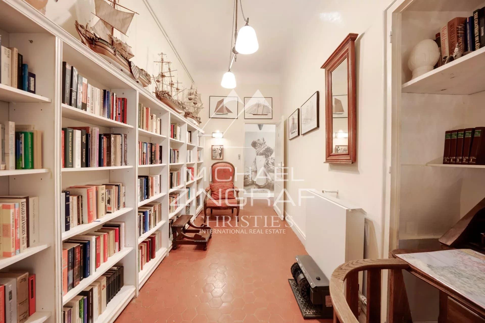 Interior of a library with shelves filled with books and decorative items.