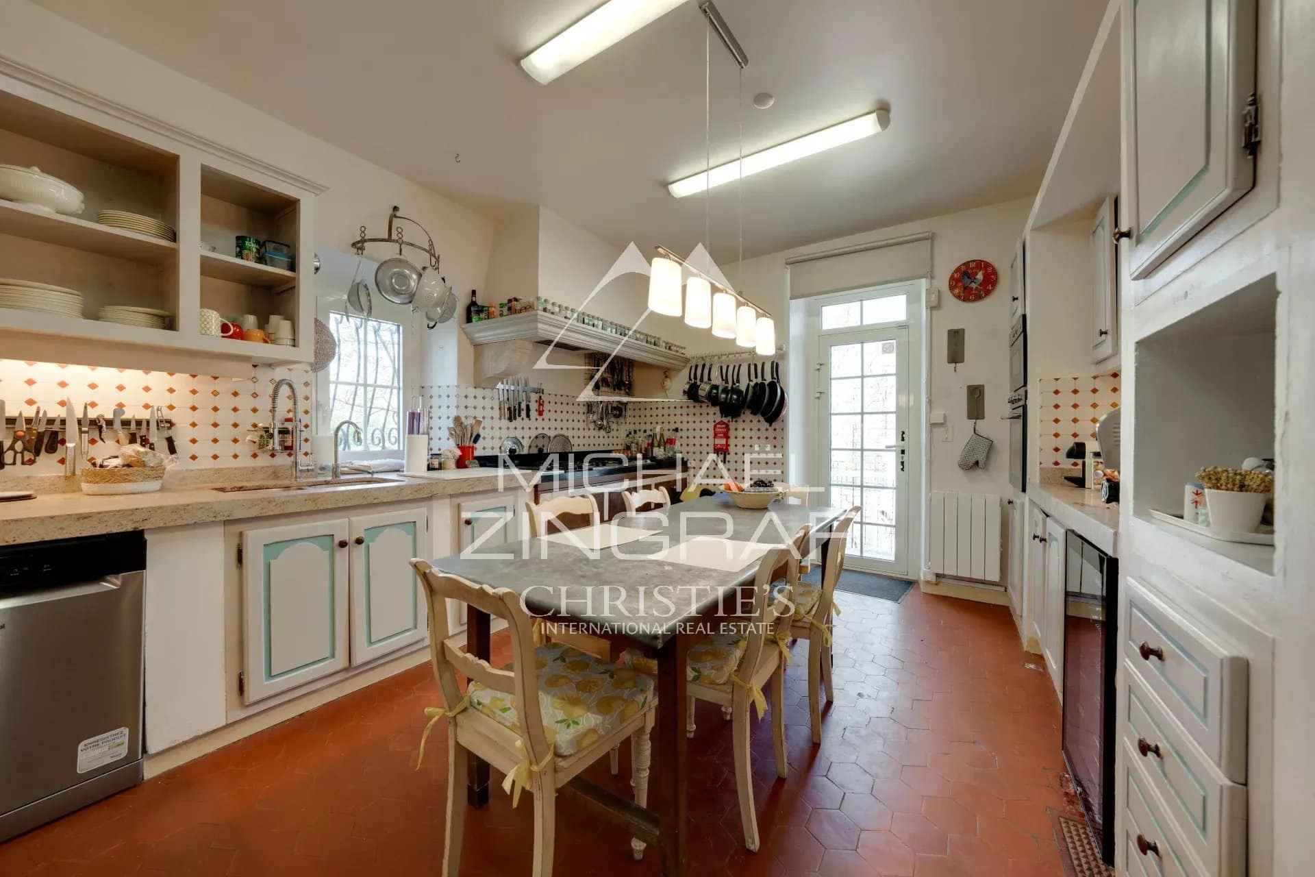 Kitchen in a Provençal estate with antique furniture and modern equipment.