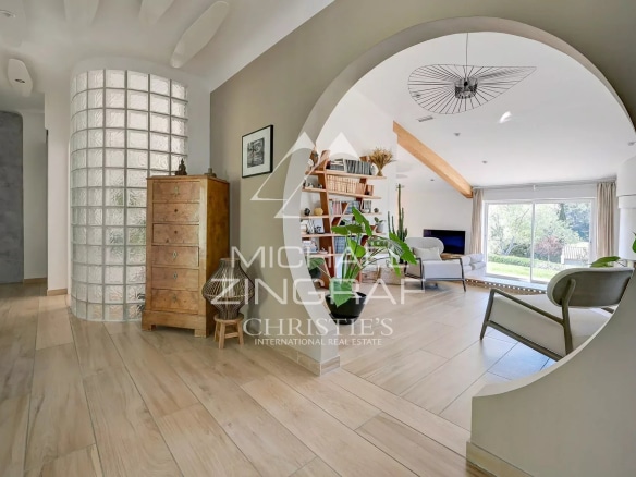 Interior of a bright house with an open living space and modern decorative elements.
