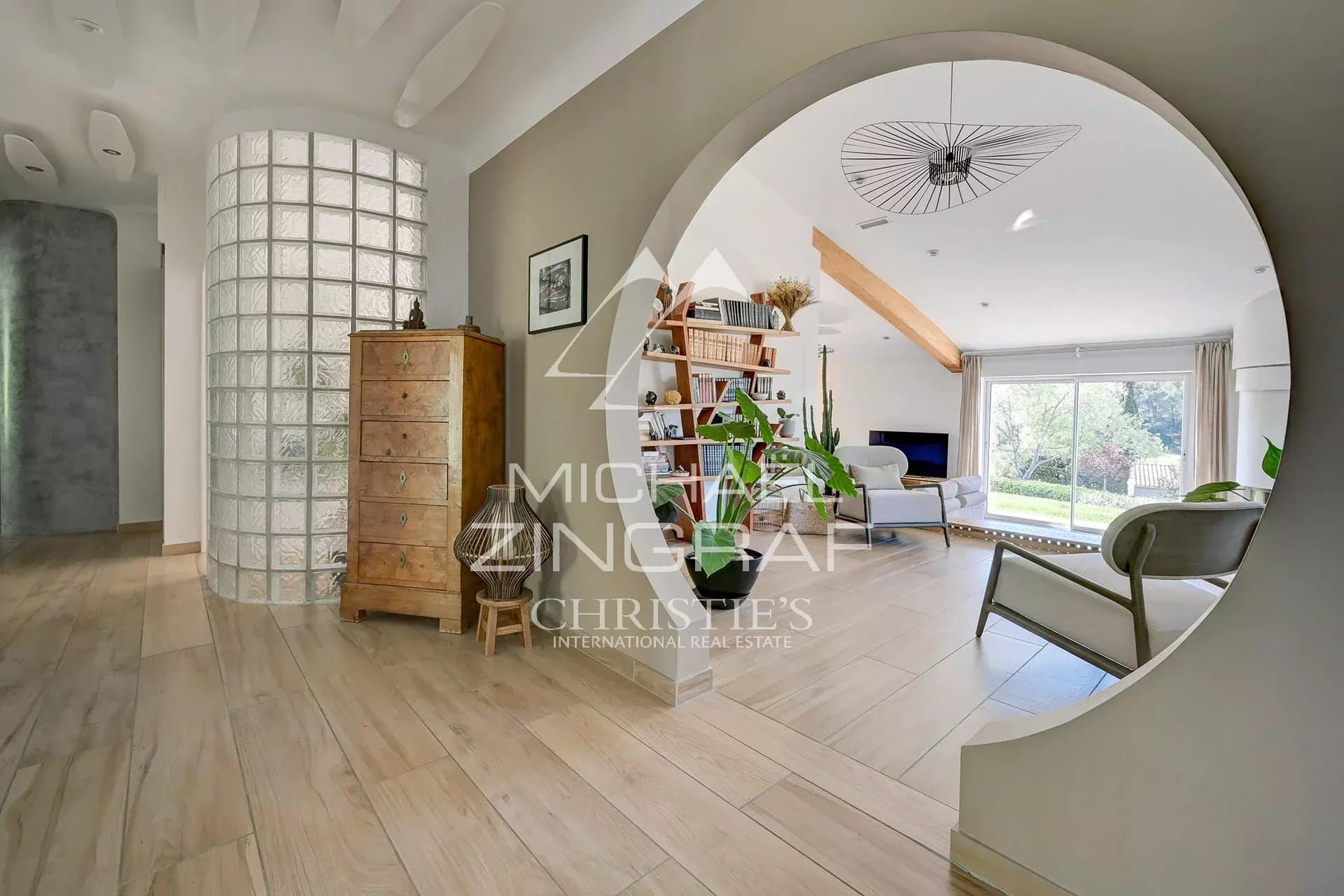 Interior of a bright house with an open living space and modern decorative elements.