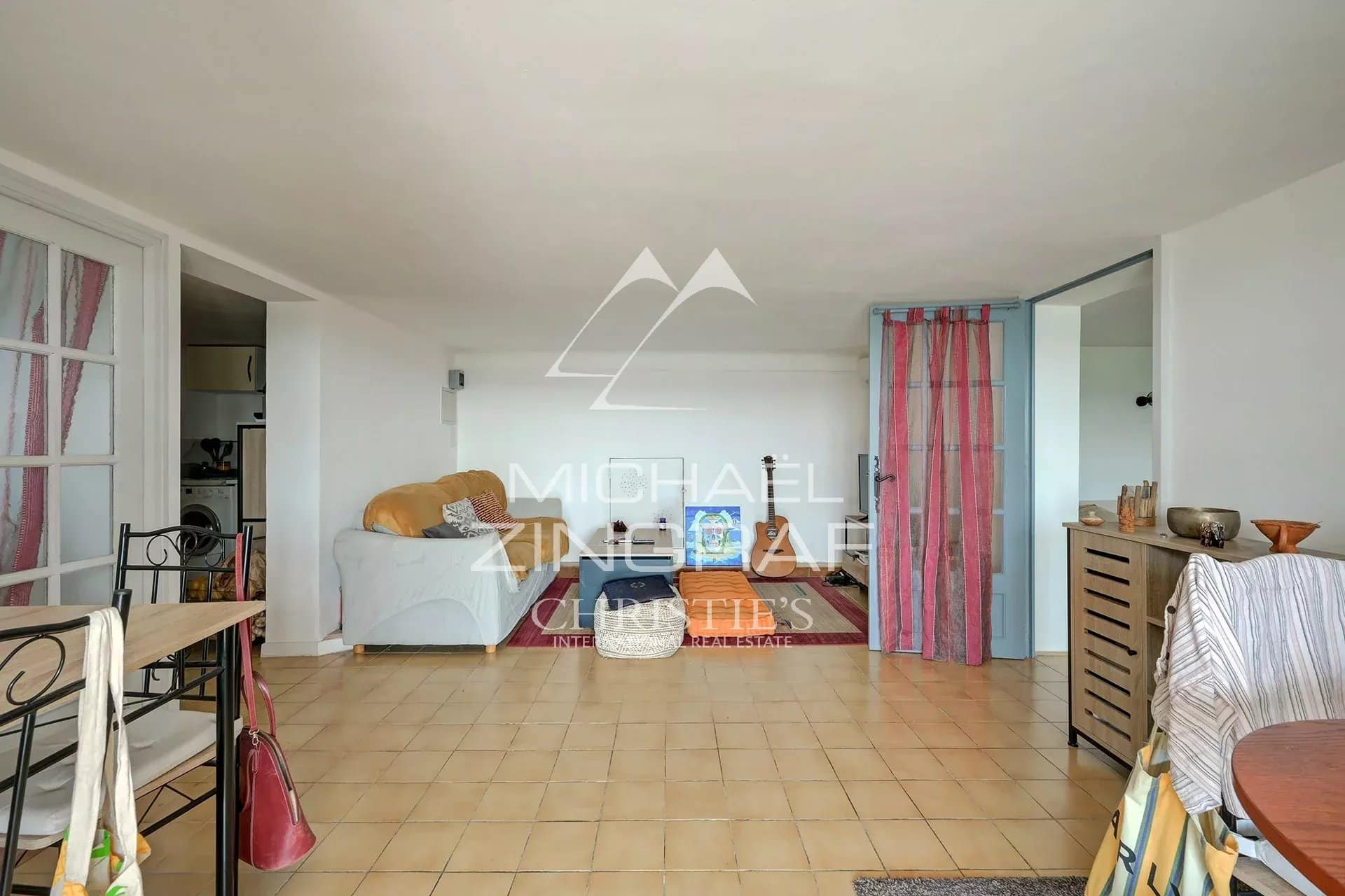 Interior of a property with a bright living space and simple decor.