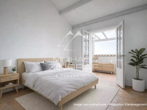 Bright room with double bed and light wood furniture, windows opening onto a balcony.