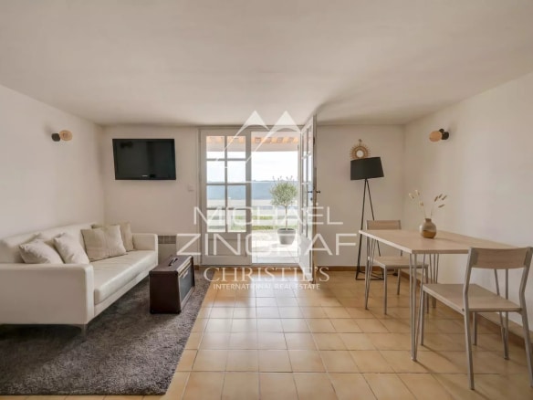 Interior of a property with living room and dining room, overlooking Lake Esparron.