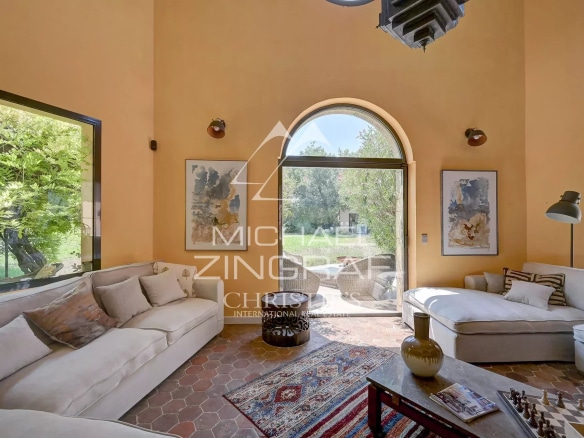 Bright interior of a luxury property with comfortable living room and large windows.